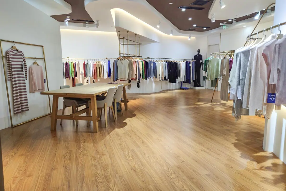 Knitwear samples displayed on clothing racks in the showroom.