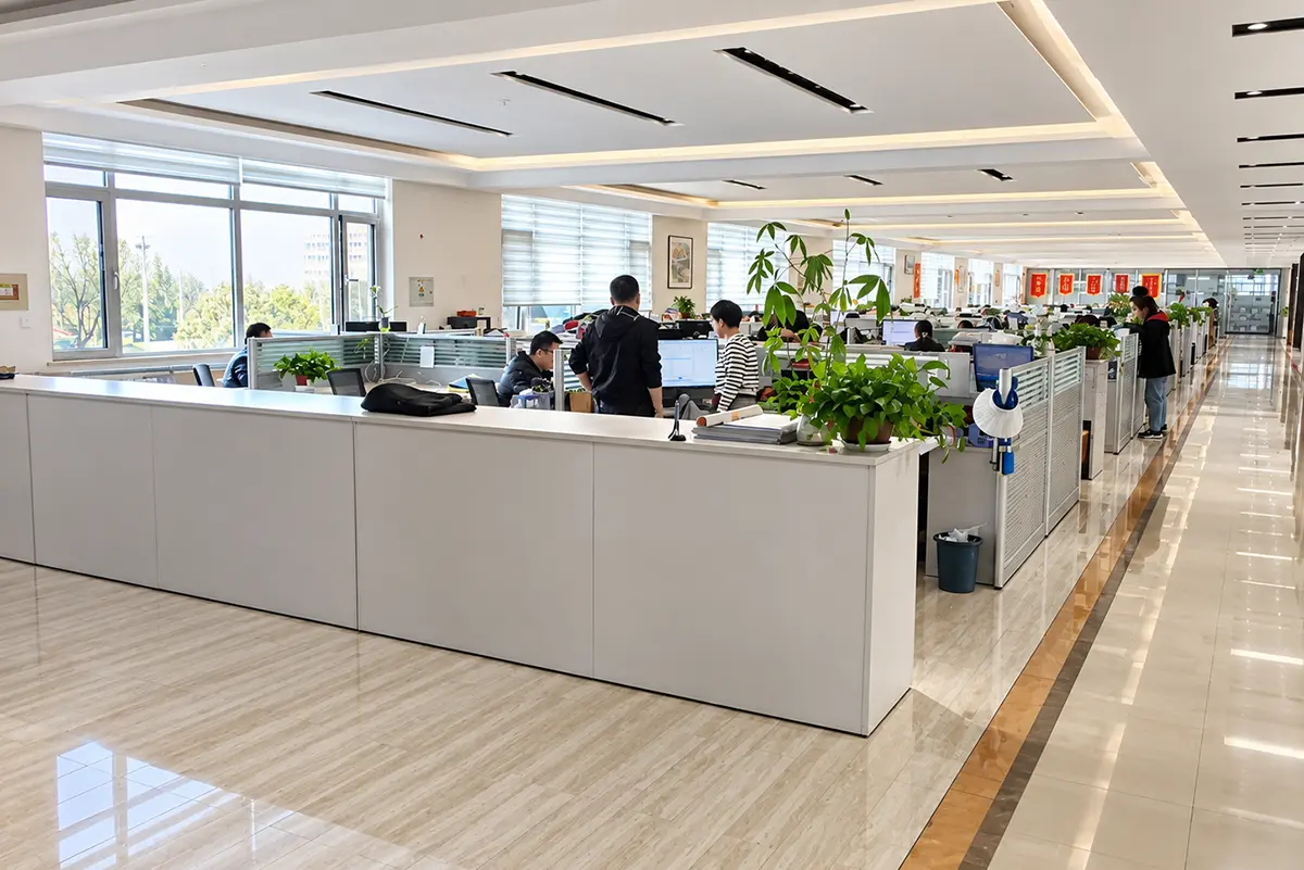 Team members working at desks in an open-plan office.
