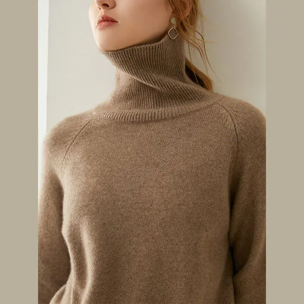 Model wearing a brown turtleneck sweater with raglan sleeves.