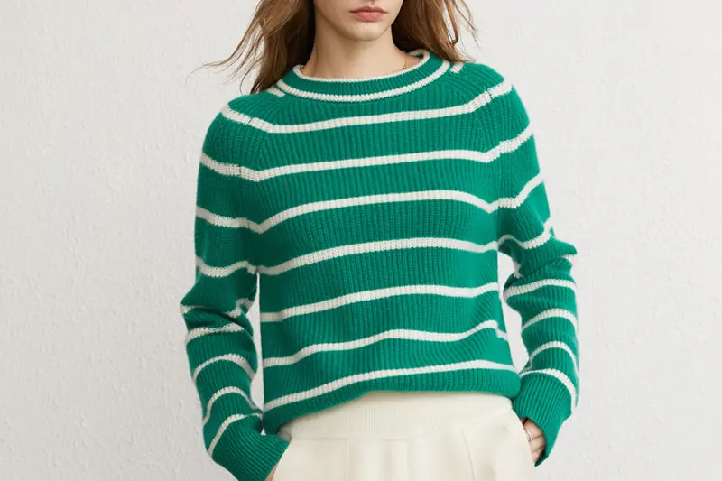 Green ribbed crew-neck sweater with cream horizontal stripes.