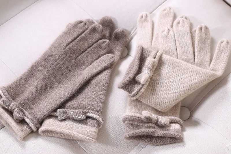 Taupe and cream full-finger knit gloves with cuff details.
