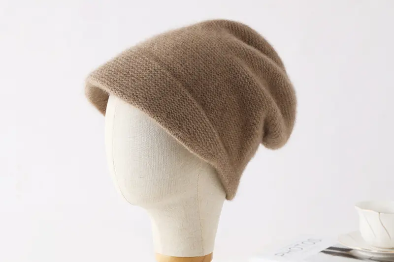 Slouchy taupe knit beanie displayed on a mannequin head.