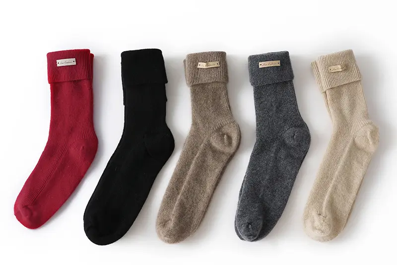 Knitted socks in red, black, taupe, dark gray, and cream.